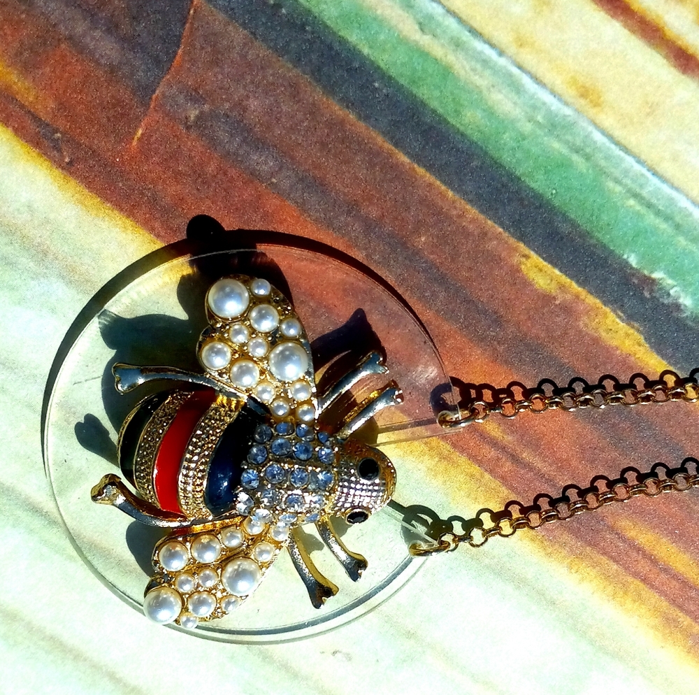 Gold Bee Necklace on clear lily pad with pearls and jewls long.